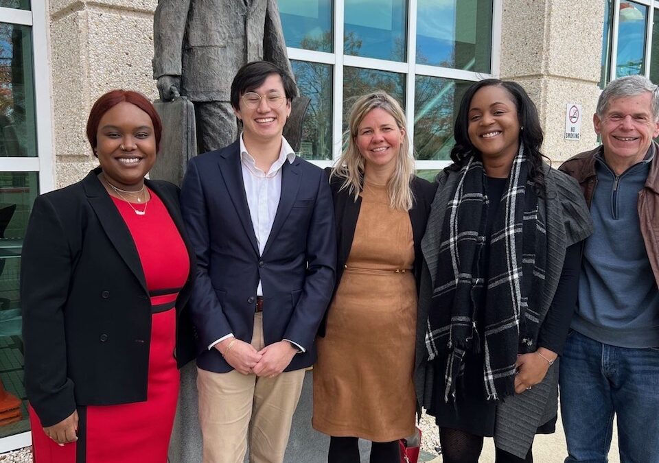 The litigation team and defendant stand outside the courthoues