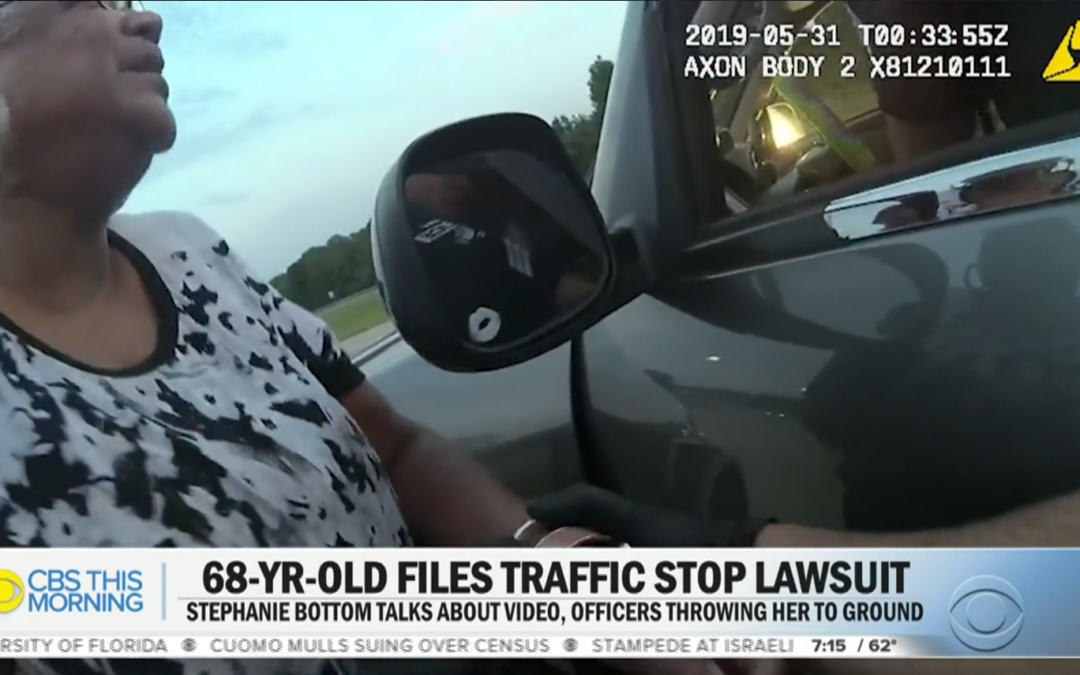 Image is a screengrab from video reporting by CBS This Morning. The chiron reads "68-Yr-Old Files Traffic Stop Lawsuit -- Stephanie Bottom Talks About Video, Officers Throwing Her to Ground." The image is of Ms. Bottom, a Black woman wearing a black and white shirt, outside her car from a police officers body camera footage in the middle of the traffic stop.